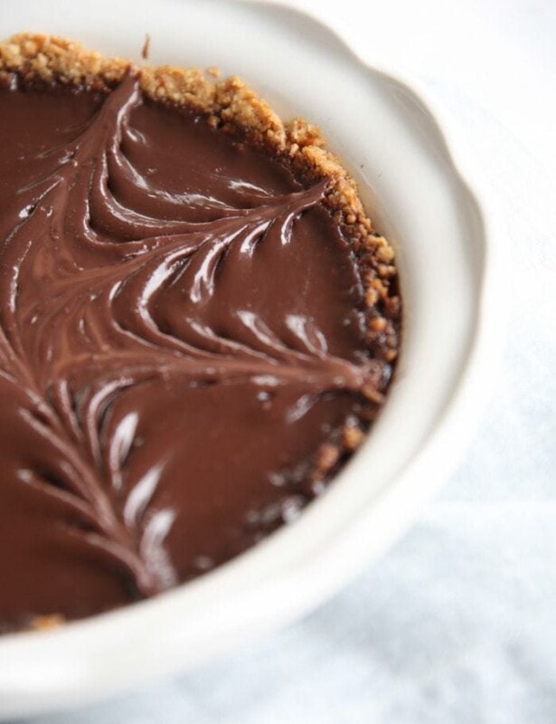 pretzel crust pie with chocolate filling in white baking dish