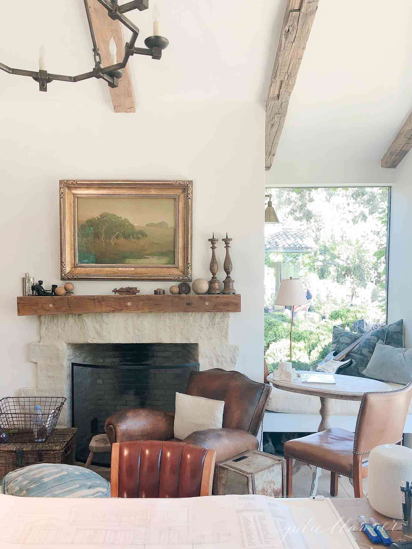 客厅有质朴的壁炉架，椅子和绘画。