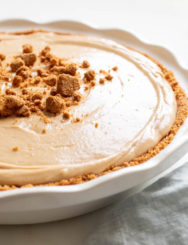 A white pie plate filled with a cookie butter cheesecake recipe.